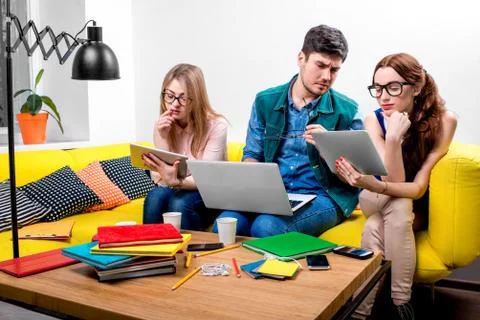 Students working on the couch Stock Photos