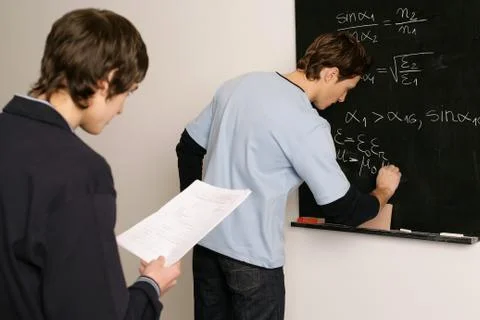 Students working on a maths problem Stock Photos