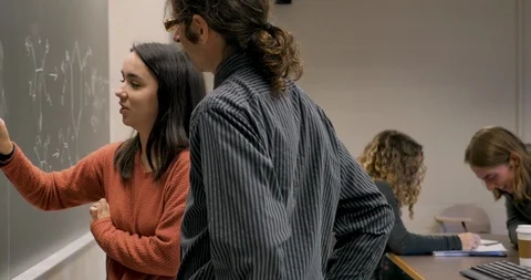 Students working with teachers learning math and science in a classroom Видео 106075292