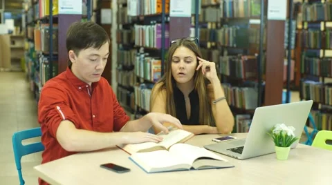 Students working together in the library Stock Footage 68577402