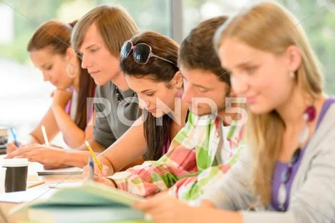 Students writing at high-school exam teens study Stock Photos