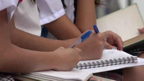 Students Writing In Notebooks Stock Photos