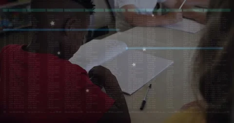 Students writing notes around classroom table with code overlay floating over Stock Footage 330058910
