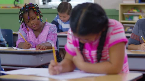 Students writing in school classroom Stock Footage 68963173
