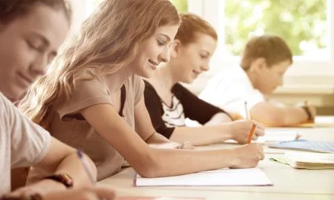 Students writing a test in school class Stock Photos