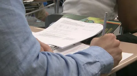 Students writing in their notebook in classroom (1 of 3) Stock Footage 10330107