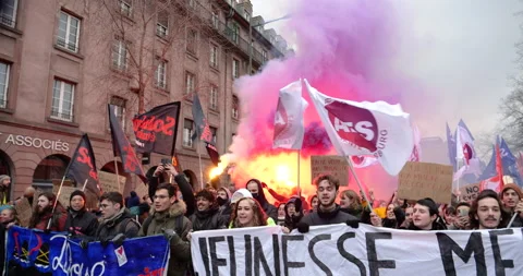 Students yelling, smoke grenades flags banners at protest against the French Stock Footage 234985152
