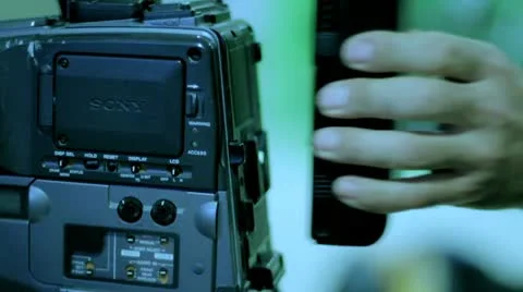 Studio 16 -  A cameraman changed the battery in a television camera. Stock Footage 10771501