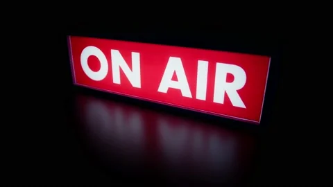 Studio On-Air lightbox casting a red glow onto a reflective surface Stock Footage 237625795