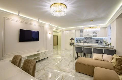 Studio apartment with classic kitchen featuring island used as dining area, and Stock Photos