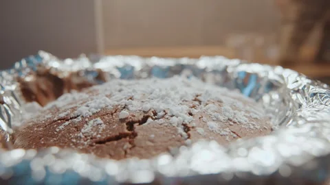 Studio chocolate cake sprinkled sugar baking tutorial with foil pan, food Stock Footage 342338805