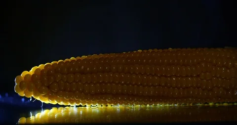 Studio close up shot. Salt is poured onto hot corn 库存影片 114989809