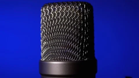 Studio Condenser Microphone Rotates on Blue Background. Stock Footage 124005471