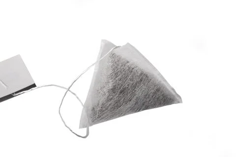 Studio equipment. A tea bag in the shape of a pyramid. On a white background. Stock Photos