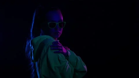 Studio exposition of lady cuddle dance future technology neon light background Stock Footage 164978667