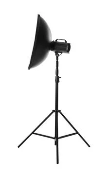 Studio flash light with reflector on tripod against white background. Profess Stock Photos