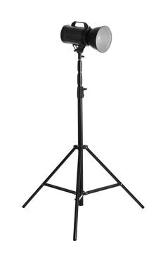 Studio flash light on tripod against white background. Professional photograp Stock Photos