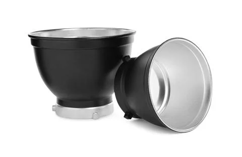 Studio flash lights reflectors on white background. Professional photographer Stock Photos