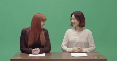 Studio, green screen, two female presenters talk to each other, London, UK Video stock 139886555