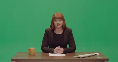 Studio, green screen, a young female newscaster at a vintage desk, London, UK Video stock 139884875