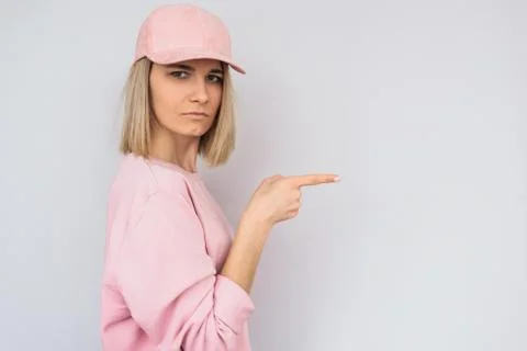 Studio horizontal shot of serious casually dressed in pink with cap Caucasian Stock Photos