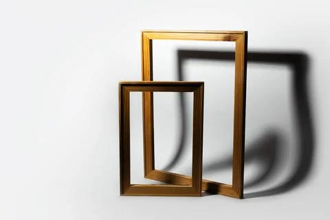 Studio image of two wooden frames on white background with shadows. Stock Photos