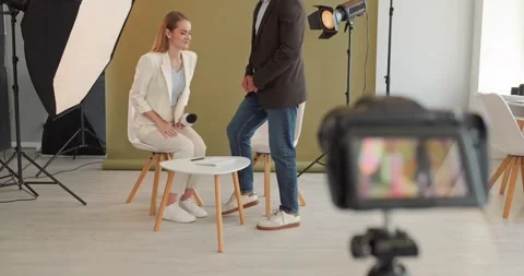 Studio interview setup with journalist and guest, camera and lights for filming Stock Footage 346640149