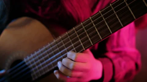Studio light, pink hands plays  guitar study classical music Stock Footage 290152102