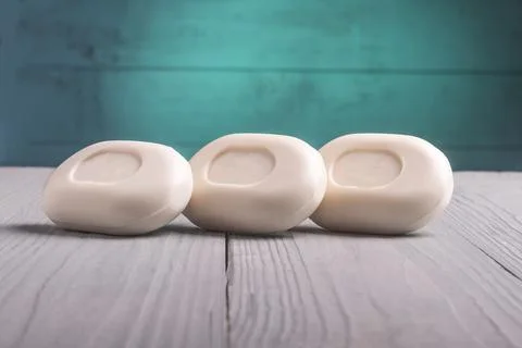 Studio lighting. a few bars of soap on a wooden background in a retro, grunge Stock Photos