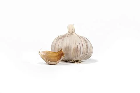 Studio lighting. A head of garlic and a small slice on a white background. Cl Foto stock