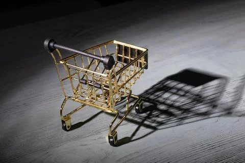 Studio lighting. light in the dark is applied to a yellow metal trolley. Clos Stock Photos