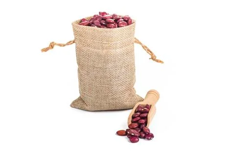 Studio lighting. red beans in a linen bag on a white background. There is a s Stock Photos