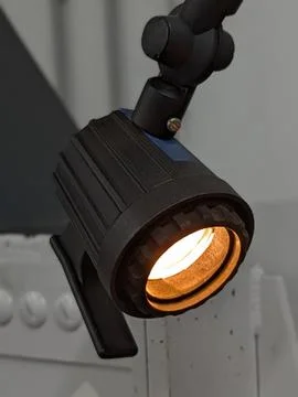 Studio Lighting Setup. Black Textured Fixture With Amber Illumination Stock Photos