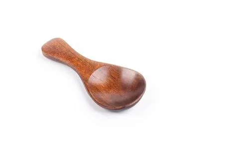 Studio lighting. small spoon from a beautiful wood for spices on a white back Stock Photos