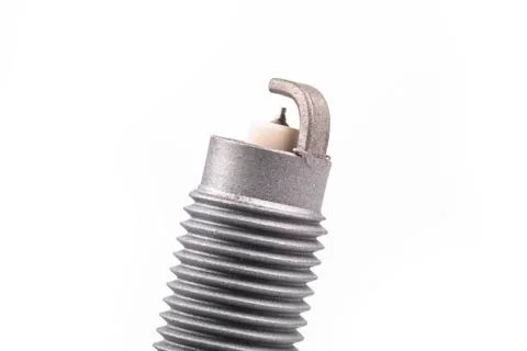 Studio lighting. spark plug from a gasoline engine. It is matte. Close-up. Stock Photos