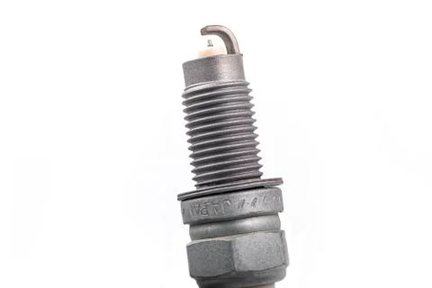 Studio lighting. spark plug from a gasoline engine. It is matte. Close-up. Stock Photos
