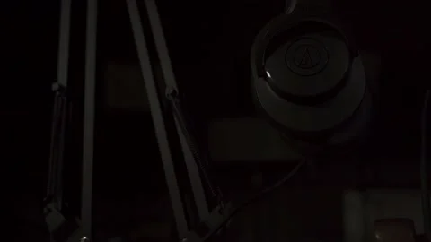 Studio lights turn on behind podcast setup. Stock Footage 132688402