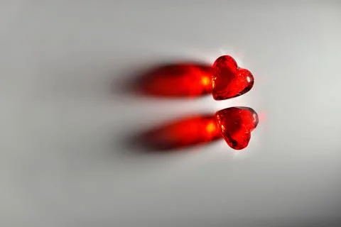 Studio mage of Two Sparkling Red Gemstone Hearts on a Grey Studio Background Stock Photos