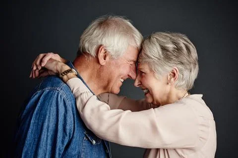 Studio, old couple and bonding with hug, love and commitment for marriage, .. Stock Photos