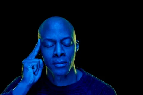 Studio photo with blue light. Black man with eyes closed Stock Photos