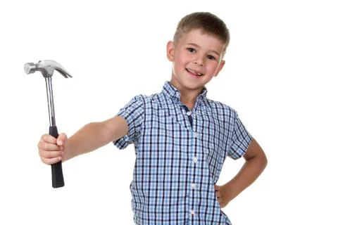 Studio picture of a cute builder boy in blue checkered shirt with a hammer on Stock Photos