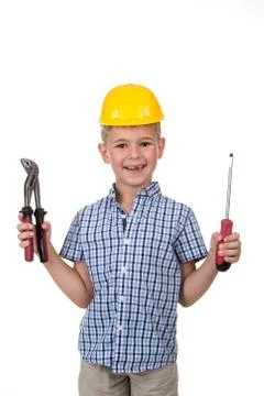 Studio picture of a young cute builder boy in a blue checkered shirt and yellow Stock Photos
