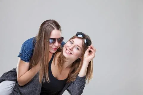 Studio portait of young twin sisters embracing Stock Photos