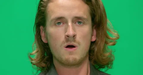 Studio, a portrait of an angry young man against a green screen, London, UK Stock Footage 139896169