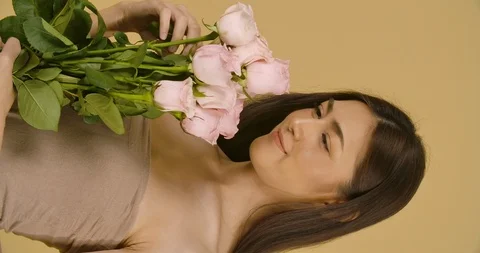 Studio Portrait Of A Beautiful Model With A Flower In Her Hand. Stock Footage 114136461