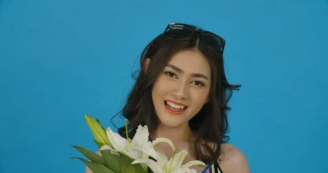 Studio Portrait Of A Beautiful Model With A Flower In Her Hand. Stock Footage 114136636