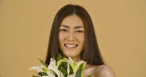 Studio Portrait Of A Beautiful Model With A Flower In Her Hand. Stock Footage 114136831