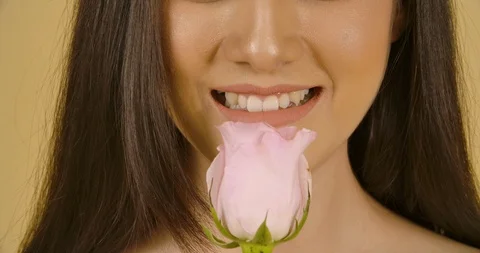Studio Portrait Of A Beautiful Model With A Flower In Her Hand. Video stock 114137387