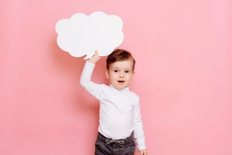 Studio portrait of a boy with a blank white board in the shape of a cloud Stock Photos