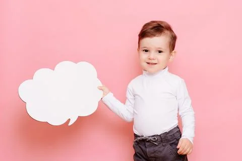Studio portrait of a boy with a blank white board in the shape of a cloud Stock Photos